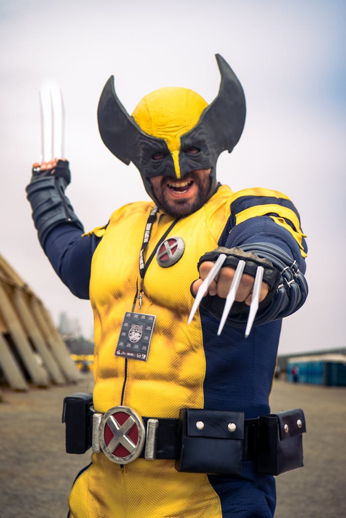 services-02 Dynamic photo of a man in a Wolverine costume posing outdoors at a cosplay event.